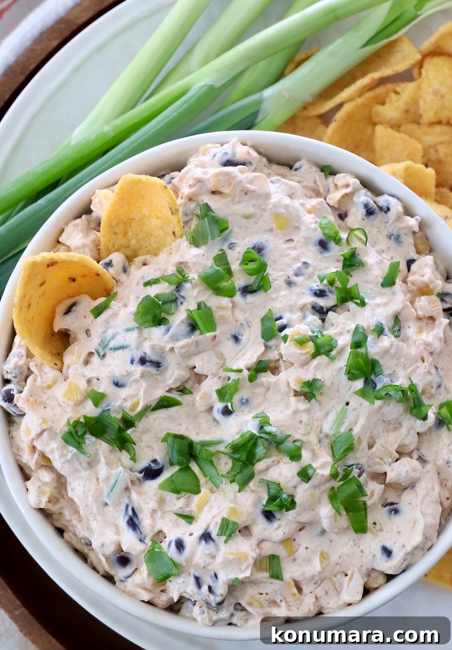 southwest dip in bowl with corn chips dipped into the dip