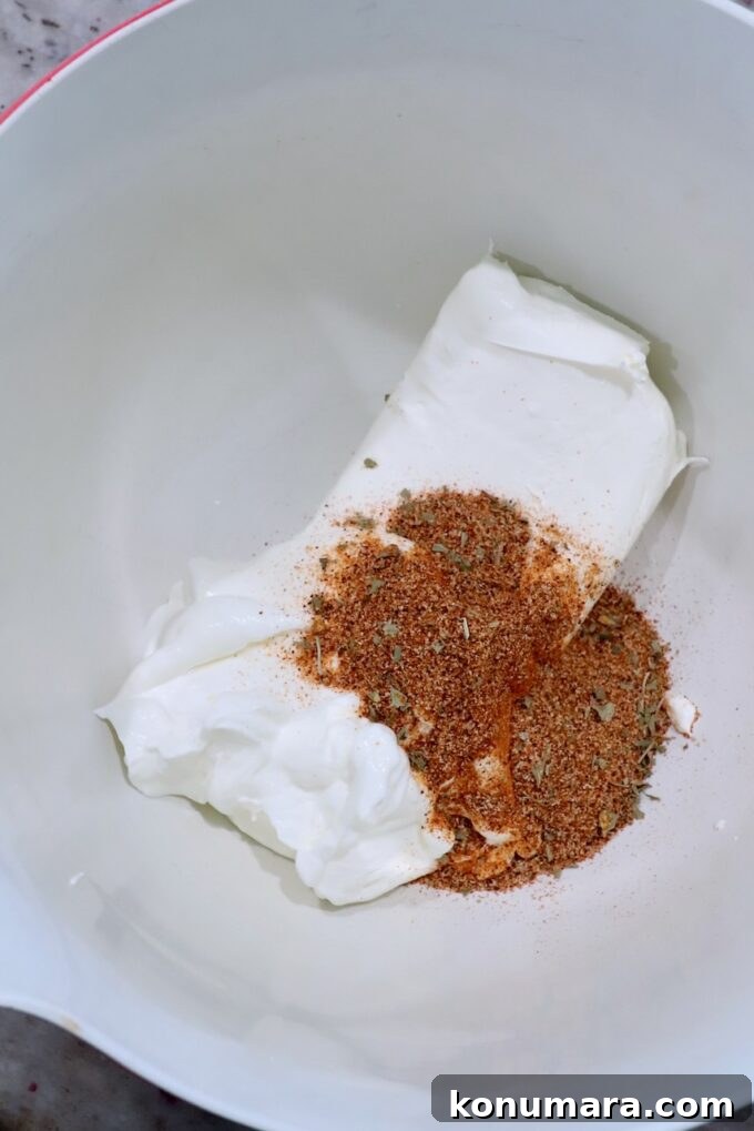 cream cheese, sour cream and spices in large bowl