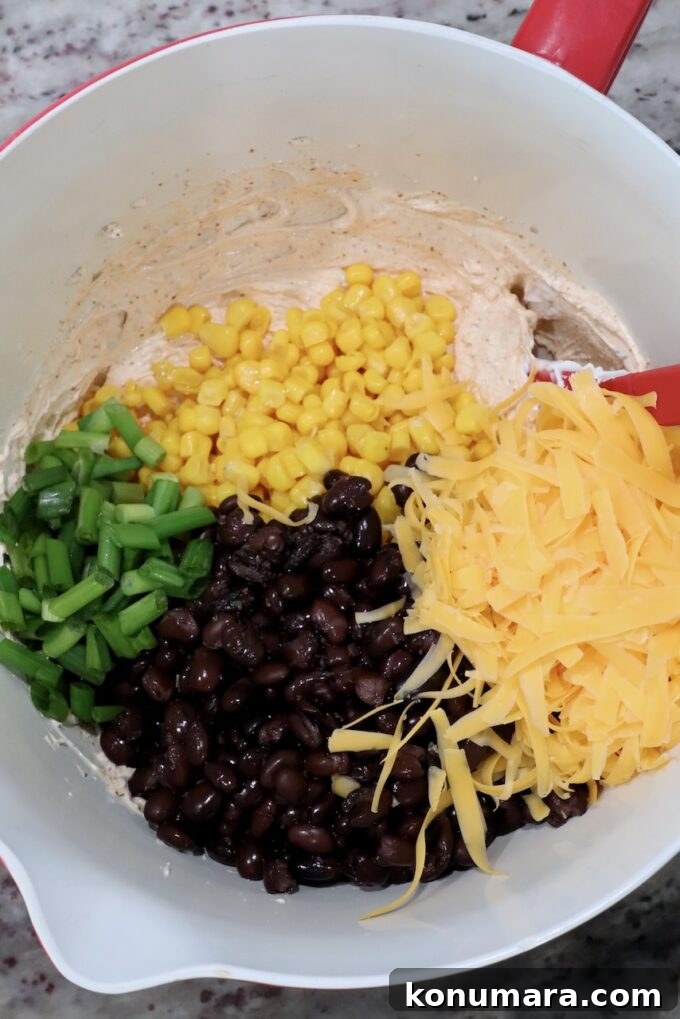 black beans, corn, green onions and shredded cheddar cheese in large bowl