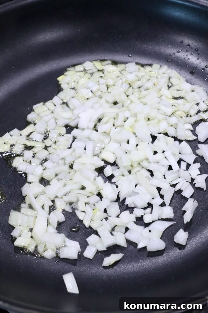 Crispy Air Fryer Taquitos Recipe 4 diced onions in skillet