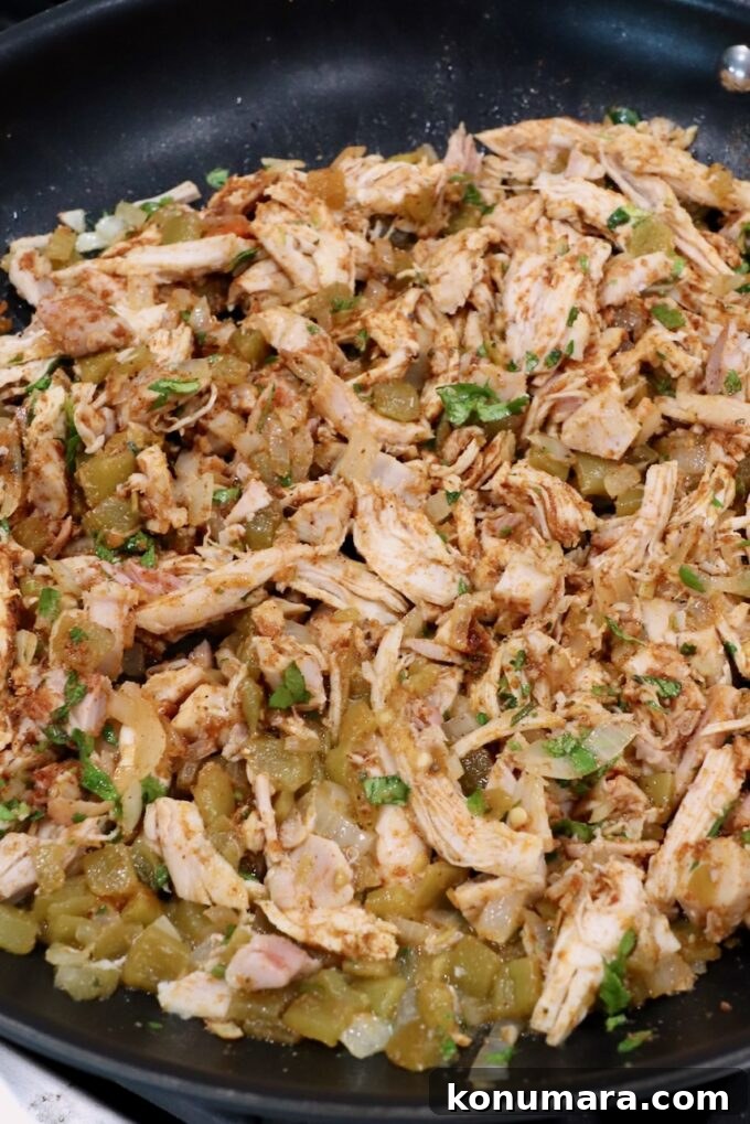 Crispy Air Fryer Taquitos Recipe 6 seasoned shredded chicken in a skillet
