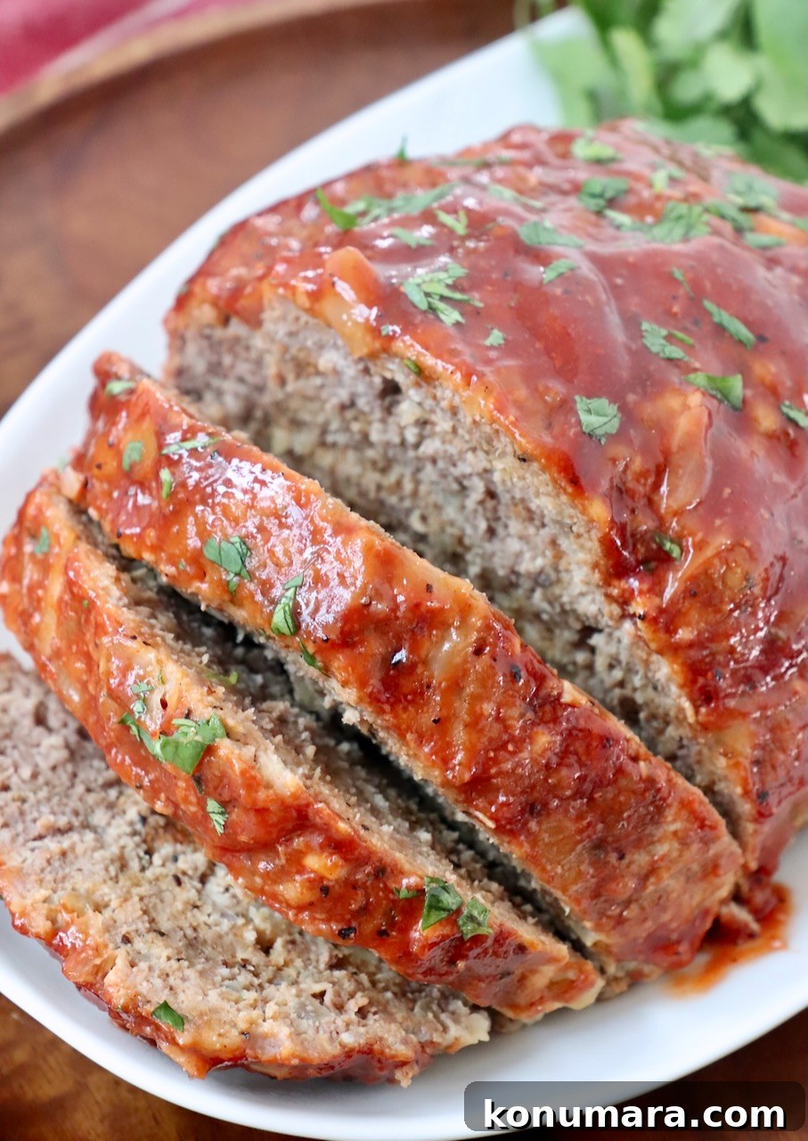 meatloaf sliced on plate with fresh parsley
