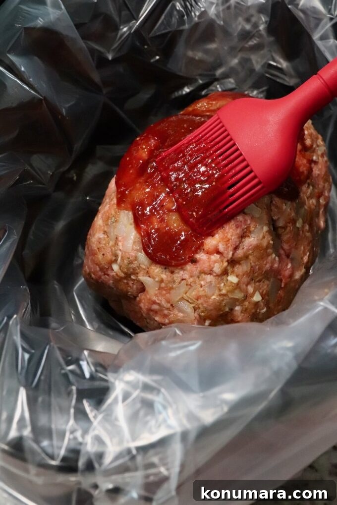 meatloaf in slow cooker brushed with bbq sauce