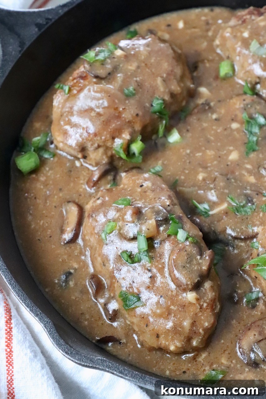 salisbury steak covered in mushroom gravy in skillet