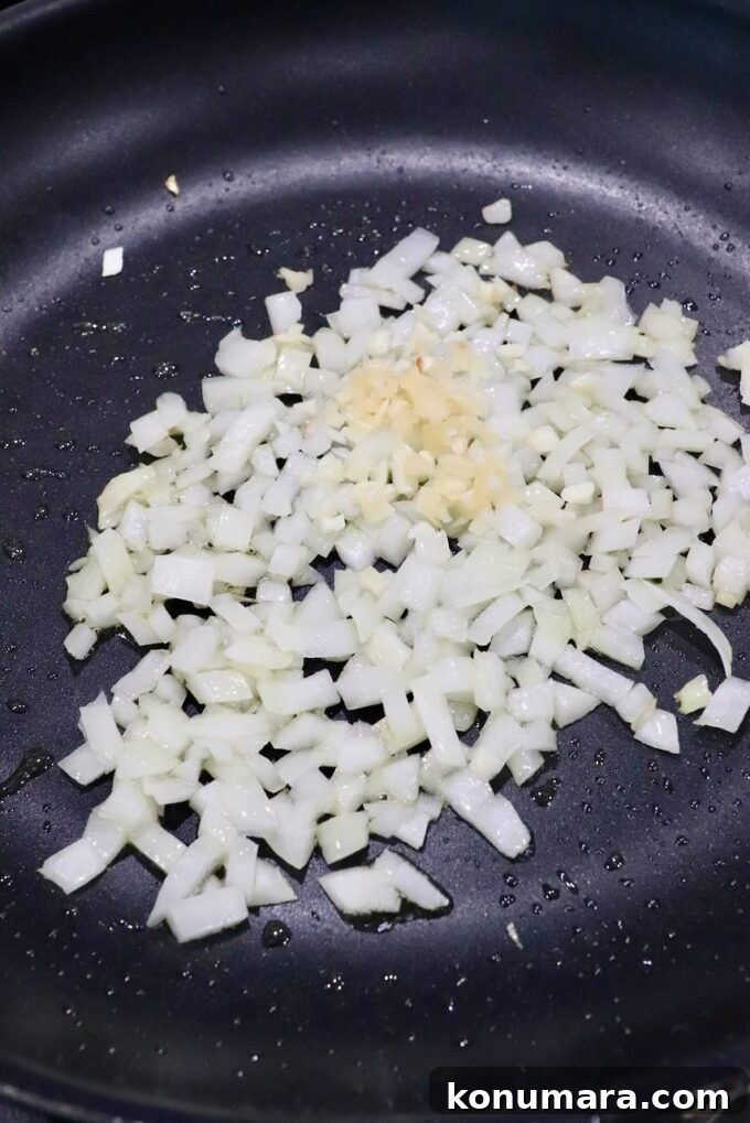 diced onions and garlic in skillet