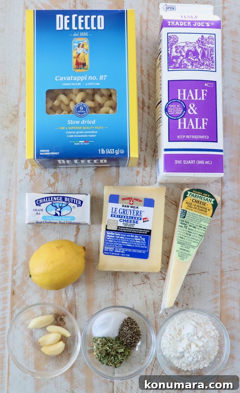 ingredients for creamy cavatappi on white wood board