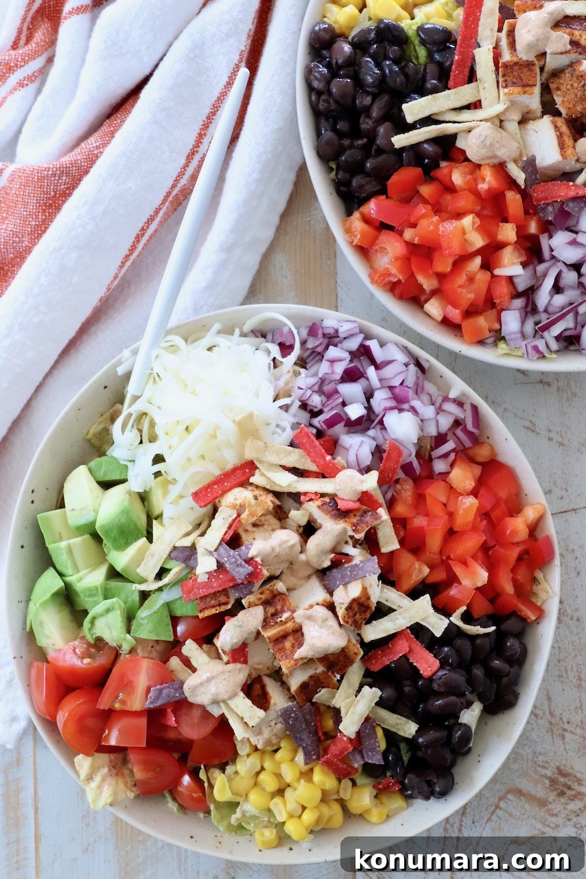 southwest salad in bowl topped with diced grilled chicken