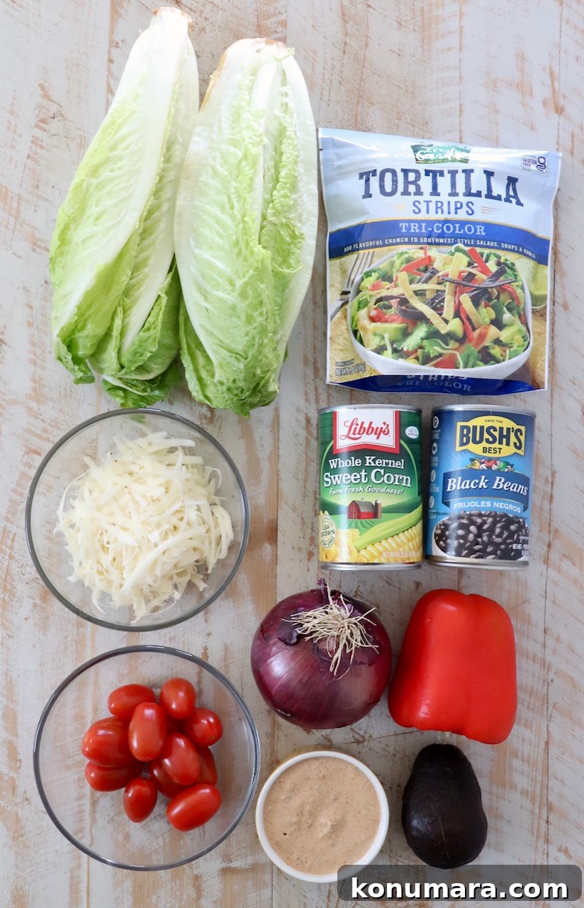 ingredients for southwest salad on white wood board