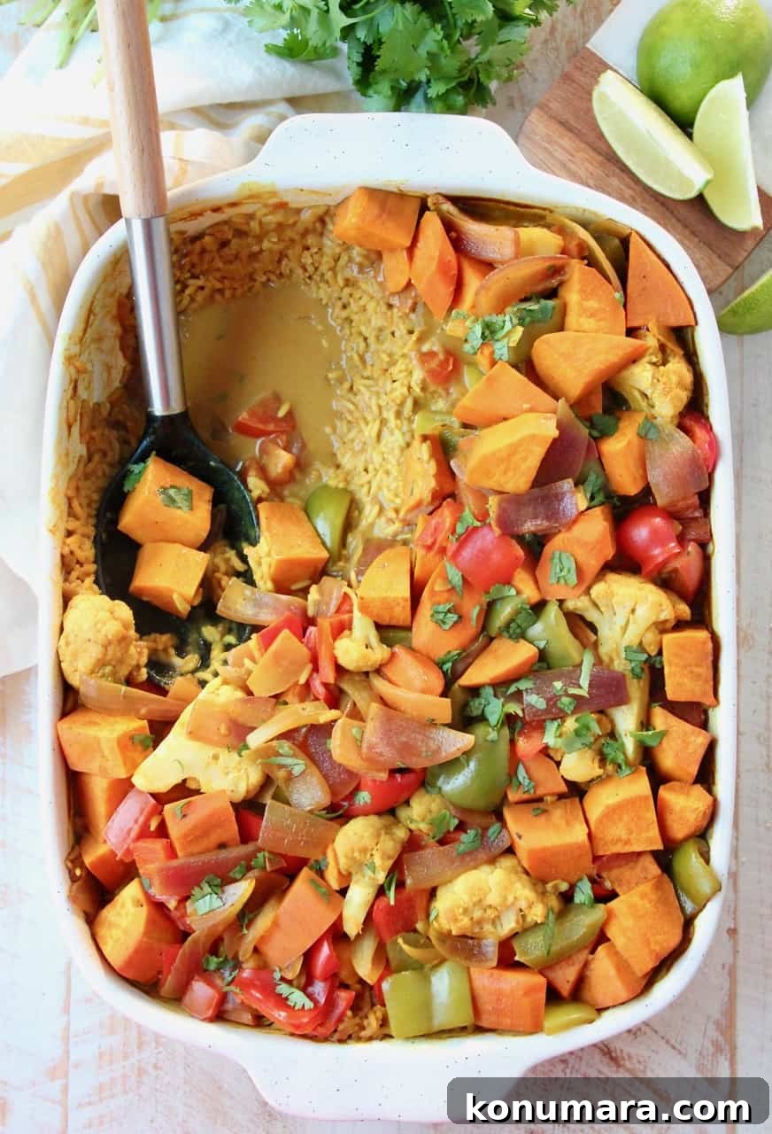 overhead image of curry casserole in dish with serving spoon