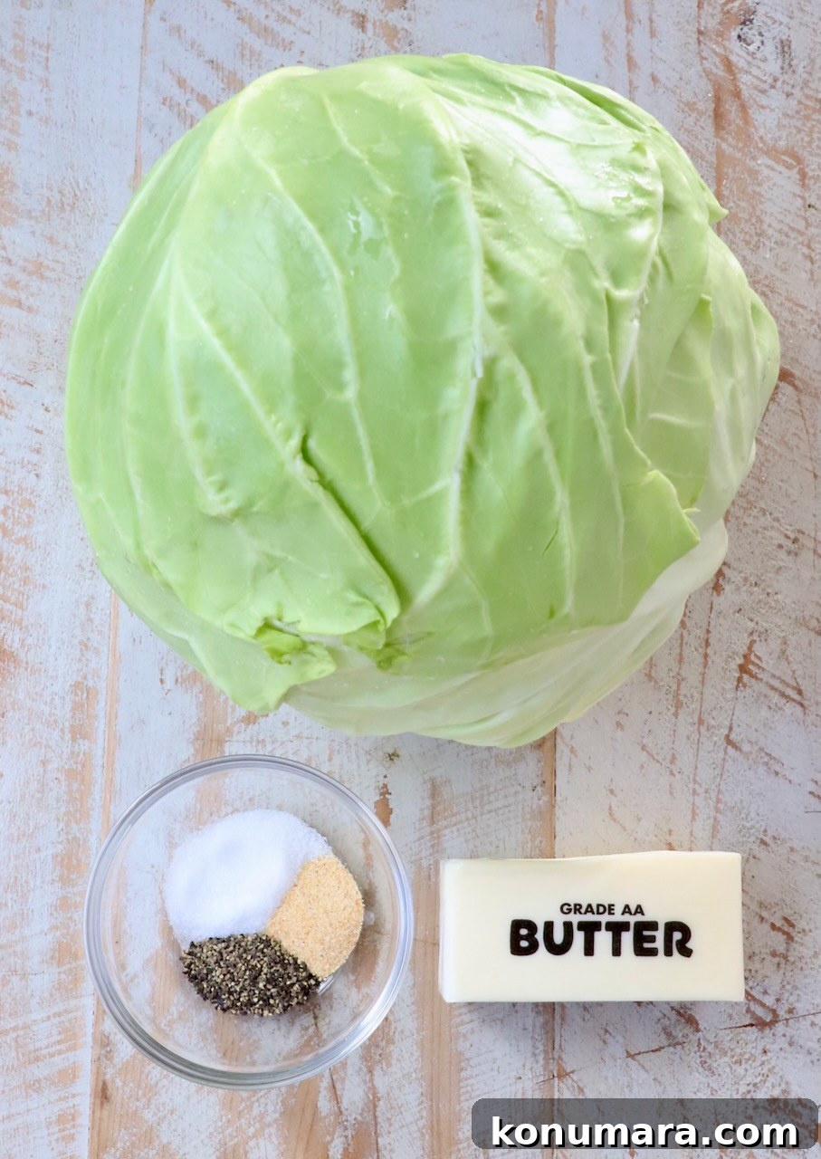 How to Make Tender Steamed Cabbage 3 ingredients for steamed cabbage on a white wood board