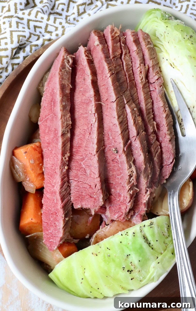 How to Make Tender Steamed Cabbage 7 sliced corned beef in serving dish with steamed cabbage