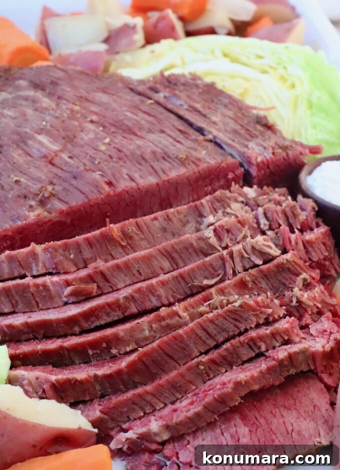 Corned Beef Seasoning Blend Recipe for Classic Flavor 7 sliced corned beef on platter with cooked carrots, potatoes and cabbage