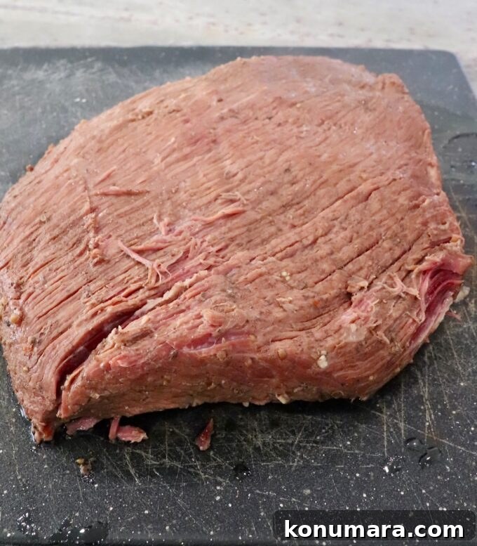 cooked brisket on cutting board