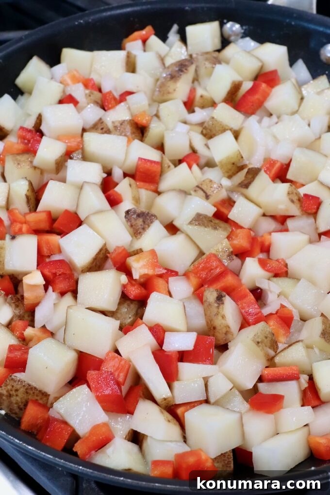 Corned Beef Hash with Crispy Potatoes 4 diced onions, potatoes and red bell pepper in a large skillet