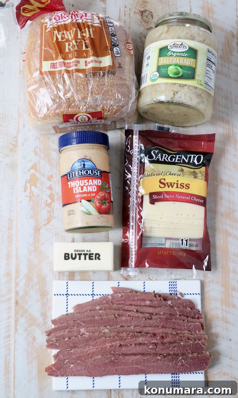 ingredients for reuben sandwich on white wood board