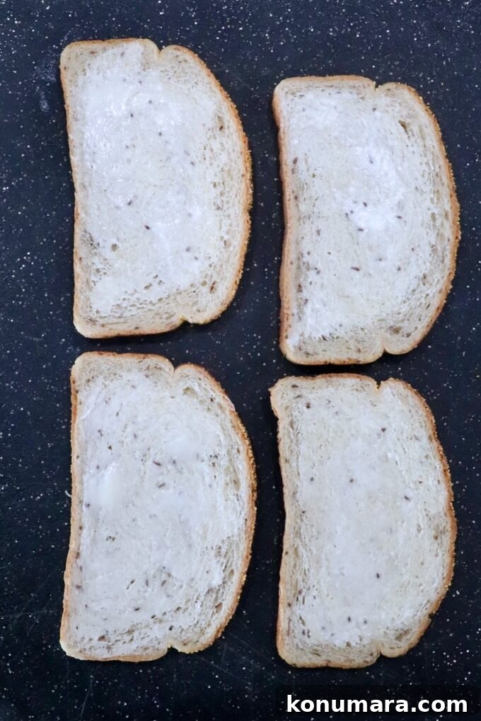 pieces of buttered bread on cutting board