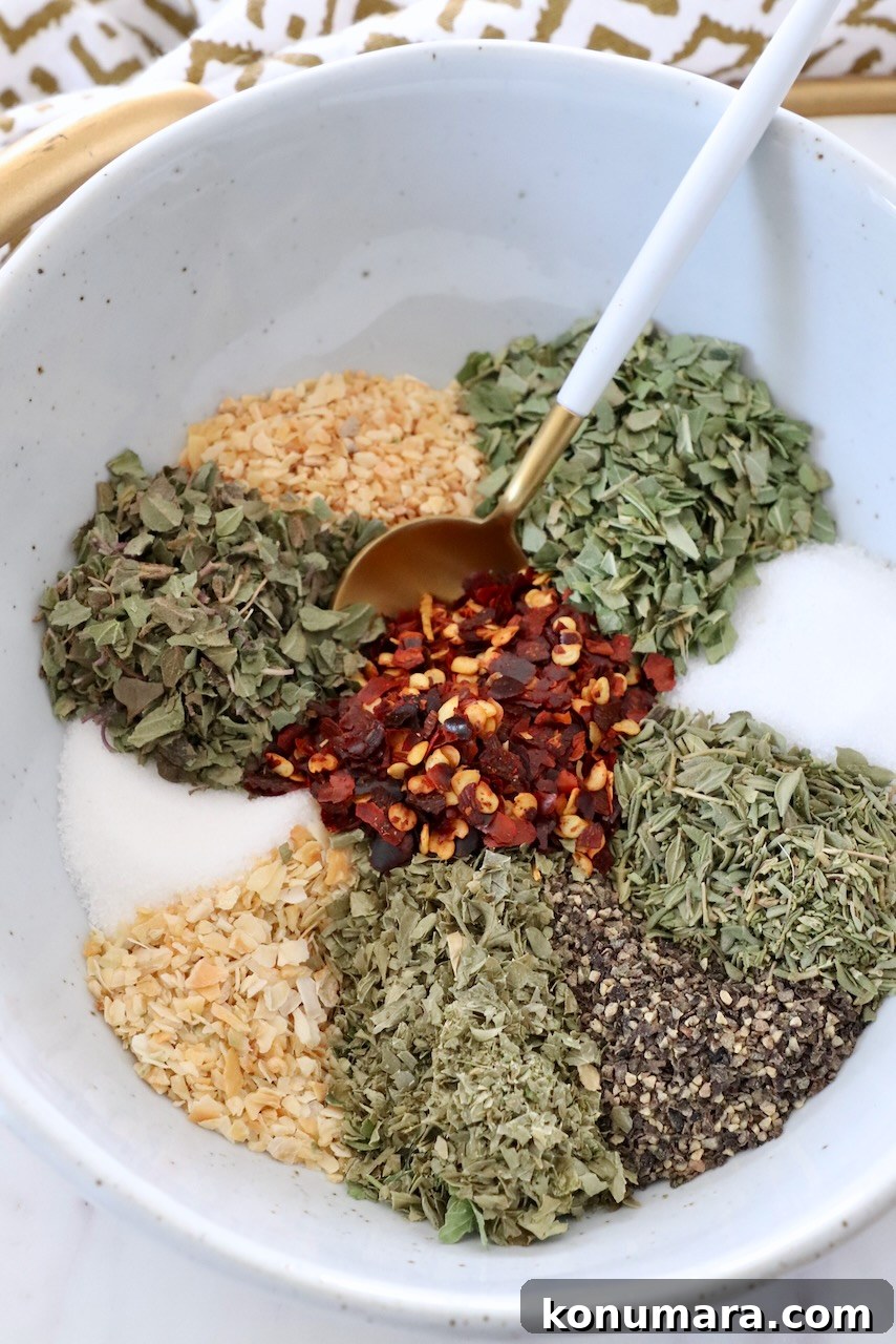 Homemade Italian Dressing Mix Recipe 5 herbs and spices separated in bowl with spoon