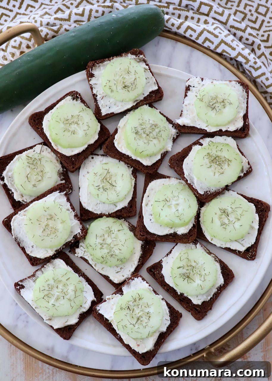open-face cucumber tea sandwiches on marble serving tray
