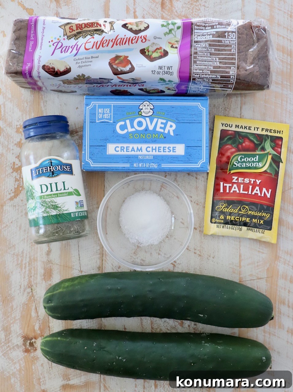 ingredients for cucumber sandwiches on white wood board