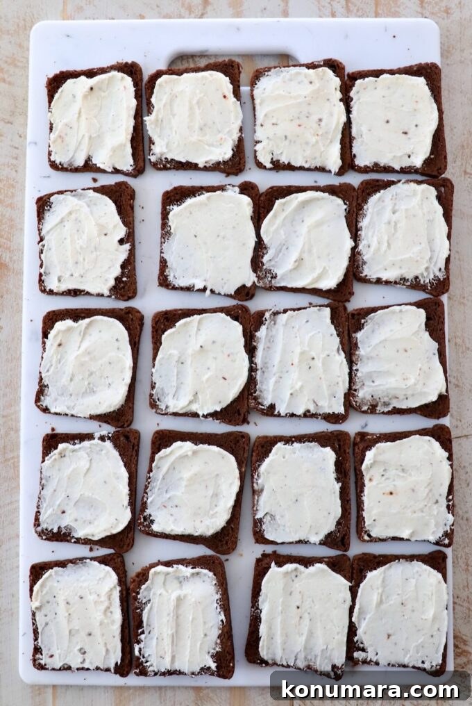 cream cheese spread on cocktail rye bread on cutting board