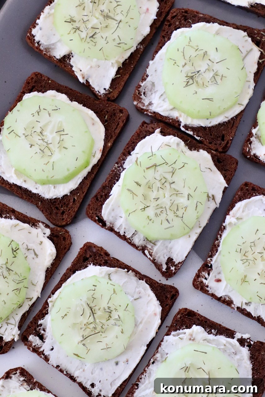 small open-faced cucumber sandwiches on plate