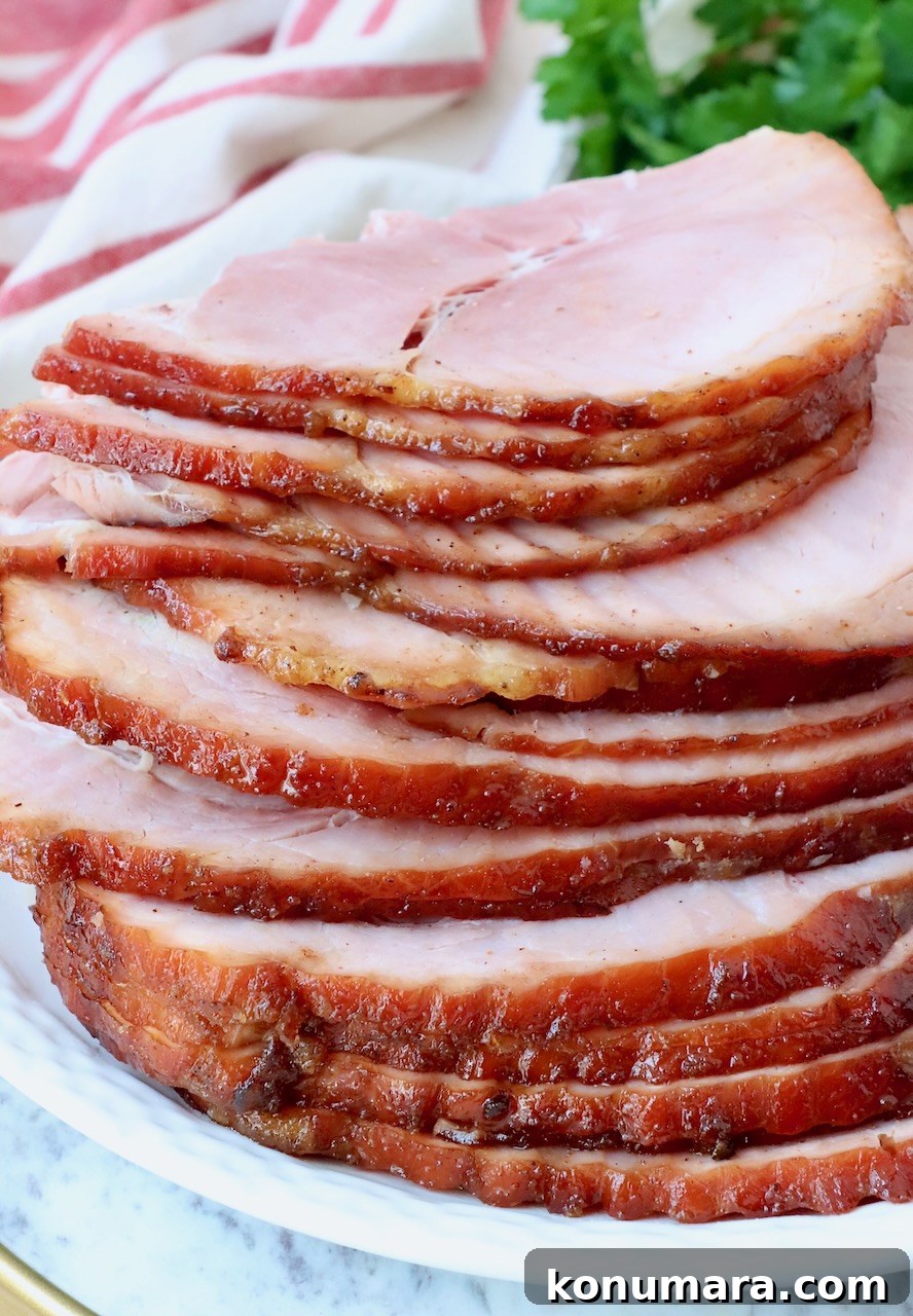 Honey-Baked Ham Recipe with Brown Sugar Glaze 2 slices of ham stacked up on a plate