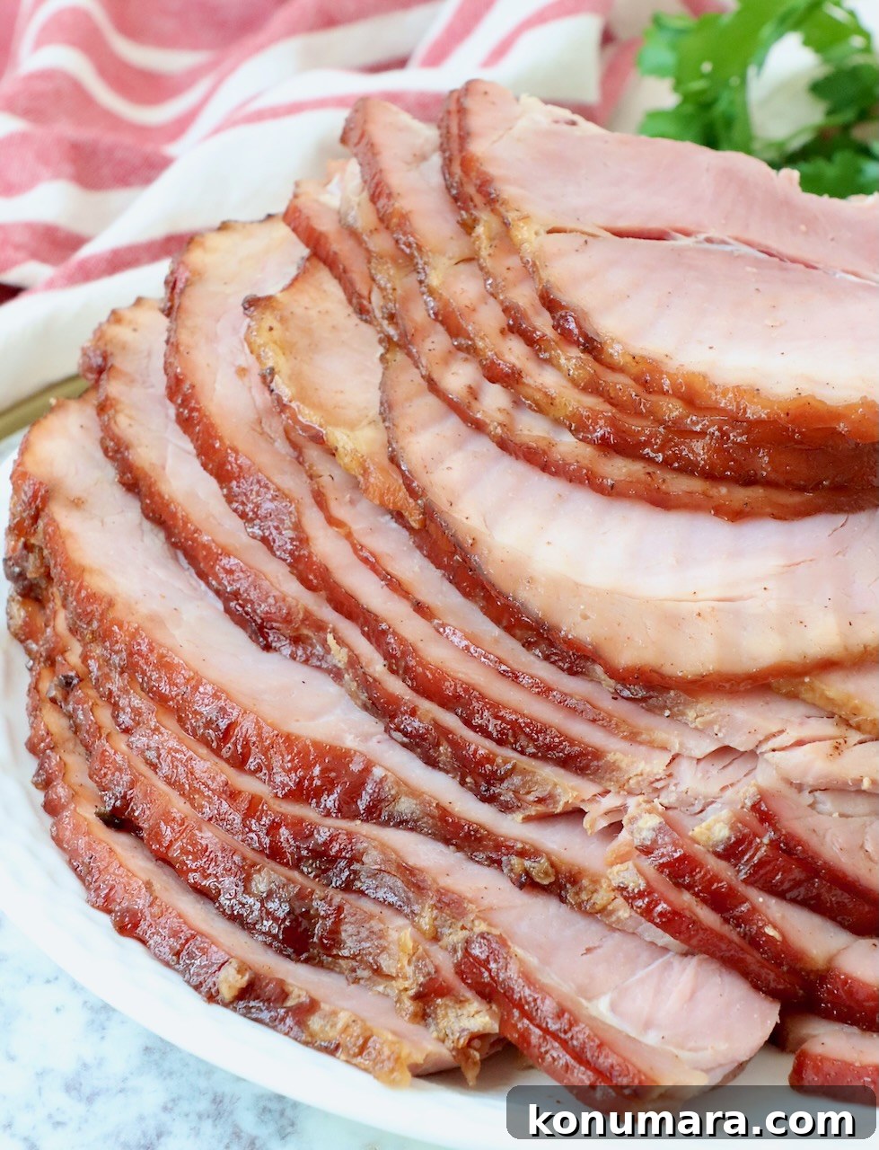 Honey-Baked Ham Recipe with Brown Sugar Glaze 12 sliced honey baked ham on plate