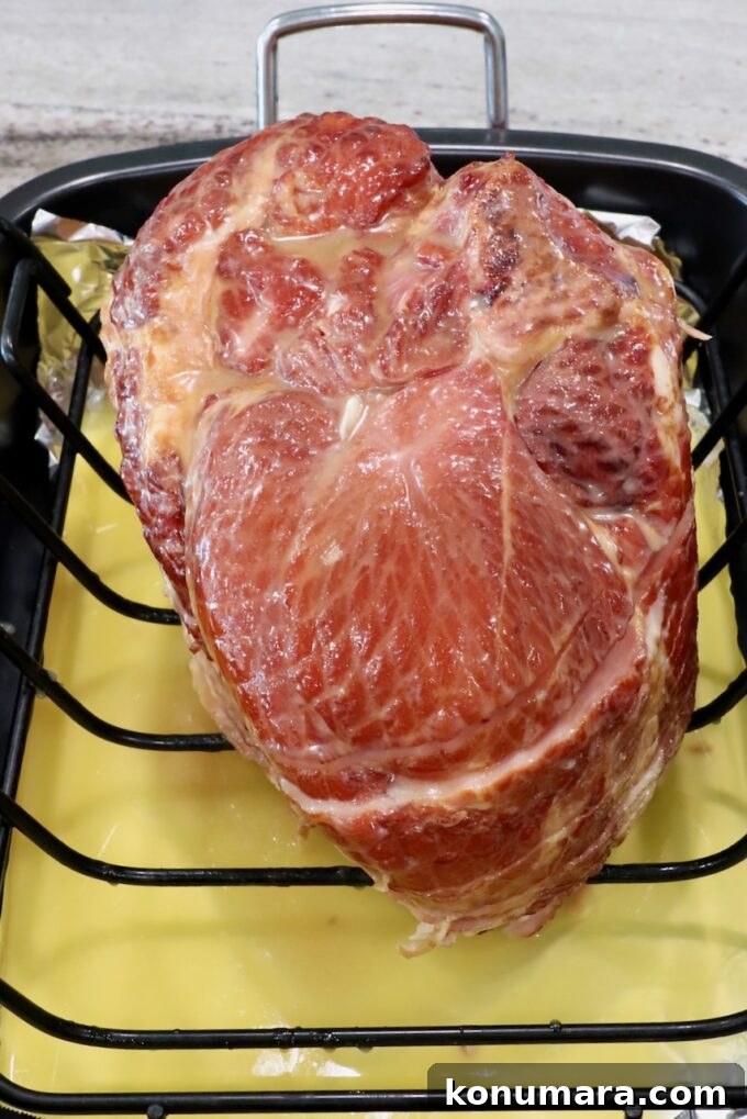 Honey-Baked Ham Recipe with Brown Sugar Glaze 6 honey glazed ham in roasting pan with pineapple juice