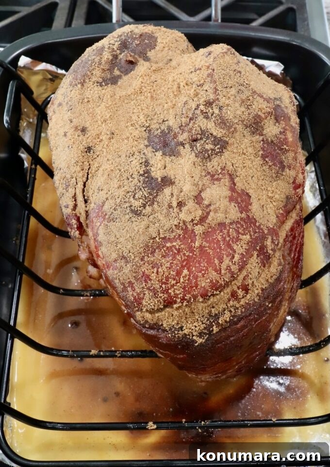 Honey-Baked Ham Recipe with Brown Sugar Glaze 8 brown sugar covered spiral ham in roasting pan