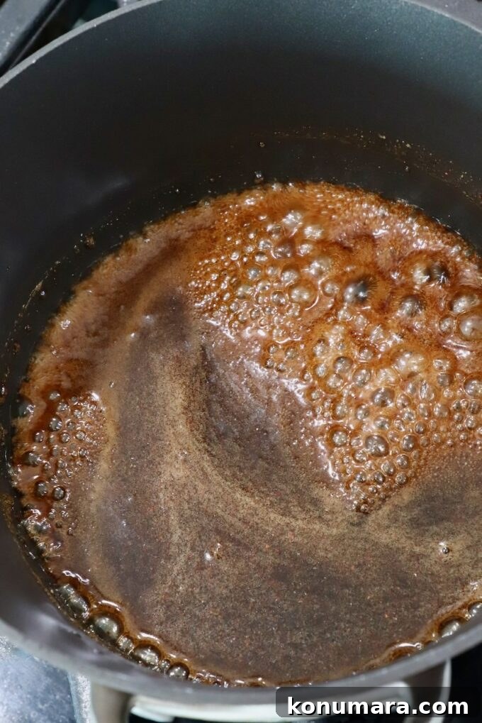 Honey-Baked Ham Recipe with Brown Sugar Glaze 9 brown sugar glaze in saucepan on the stove