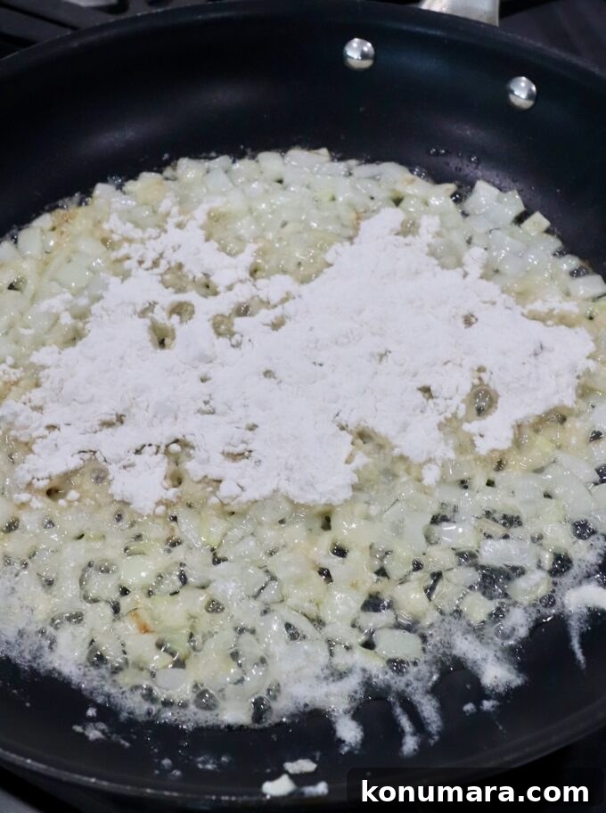 Creamy Garlic and Cheese Scalloped Potatoes Recipe 5 diced onions and minced garlic in skillet with melted butter topped with flour