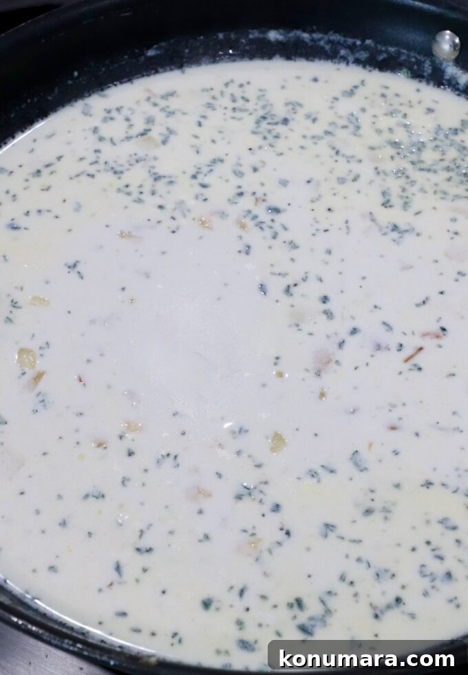 Creamy Garlic and Cheese Scalloped Potatoes Recipe 6 creamy seasoned sauce in skillet