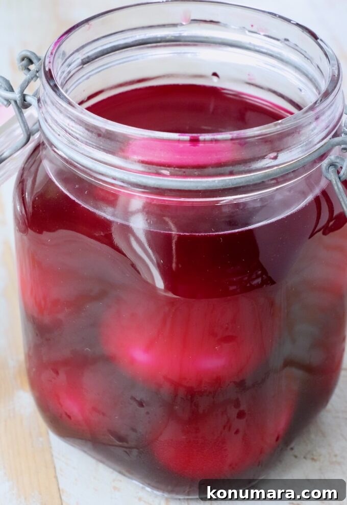 Vibrant Beet Deviled Eggs Recipe with Herbed Filling 4 hard boiled eggs in pickled beet juice in jar