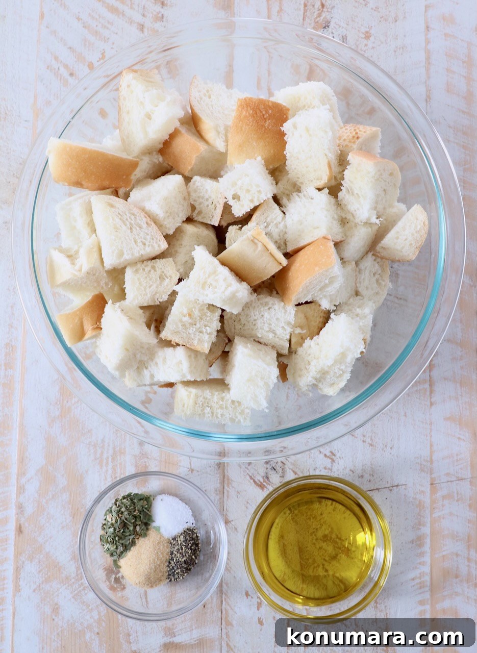 How to Make Crispy Homemade Croutons 3 ingredients for homemade croutons on white wood board