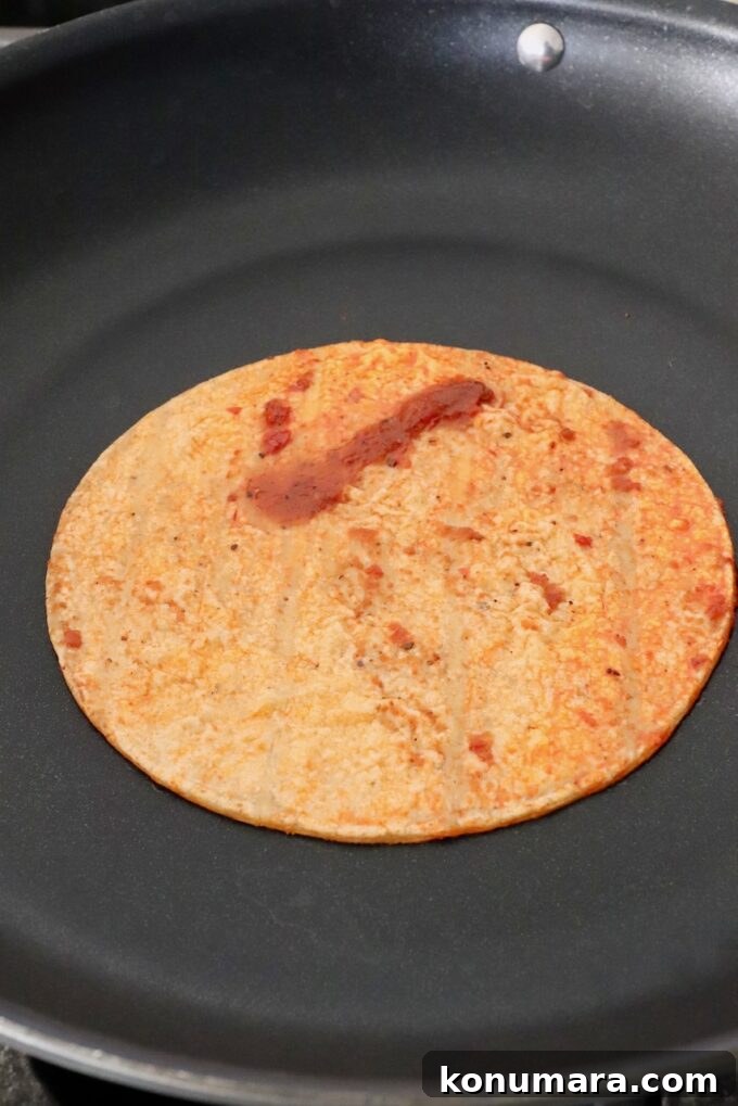 Chicken Birria Tacos with Savory Broth 6 tortilla dipped in sauce in skillet