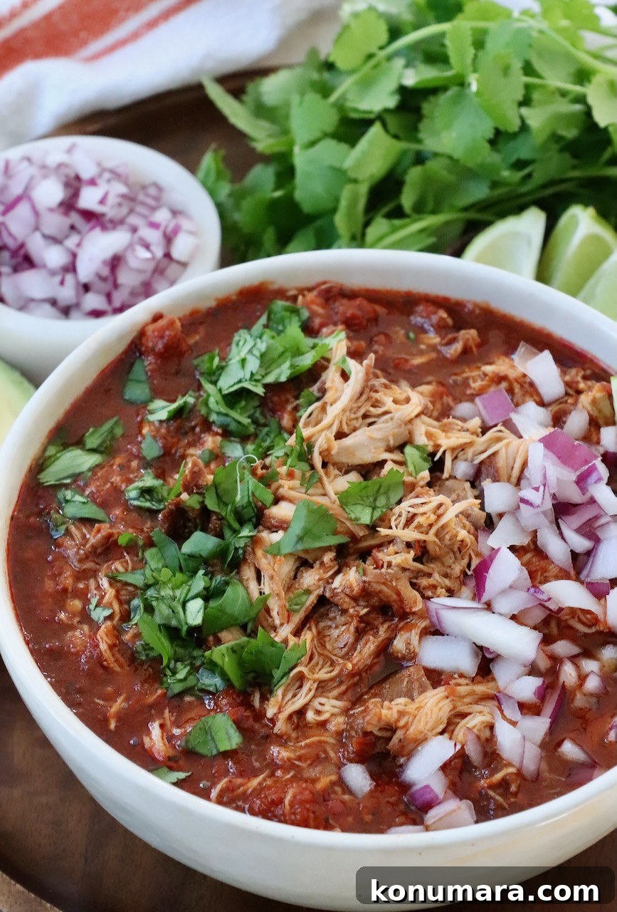 Chicken Birria Tacos with Savory Broth 8 chicken birria in bowl topped with fresh cilantro and diced red onions