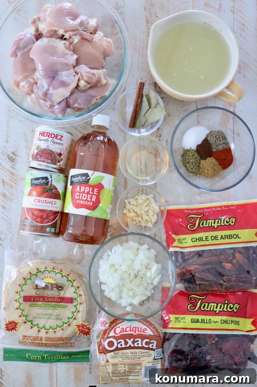 Chicken Birria Tacos with Savory Broth 3 ingredients for chicken birria tacos on white wood board