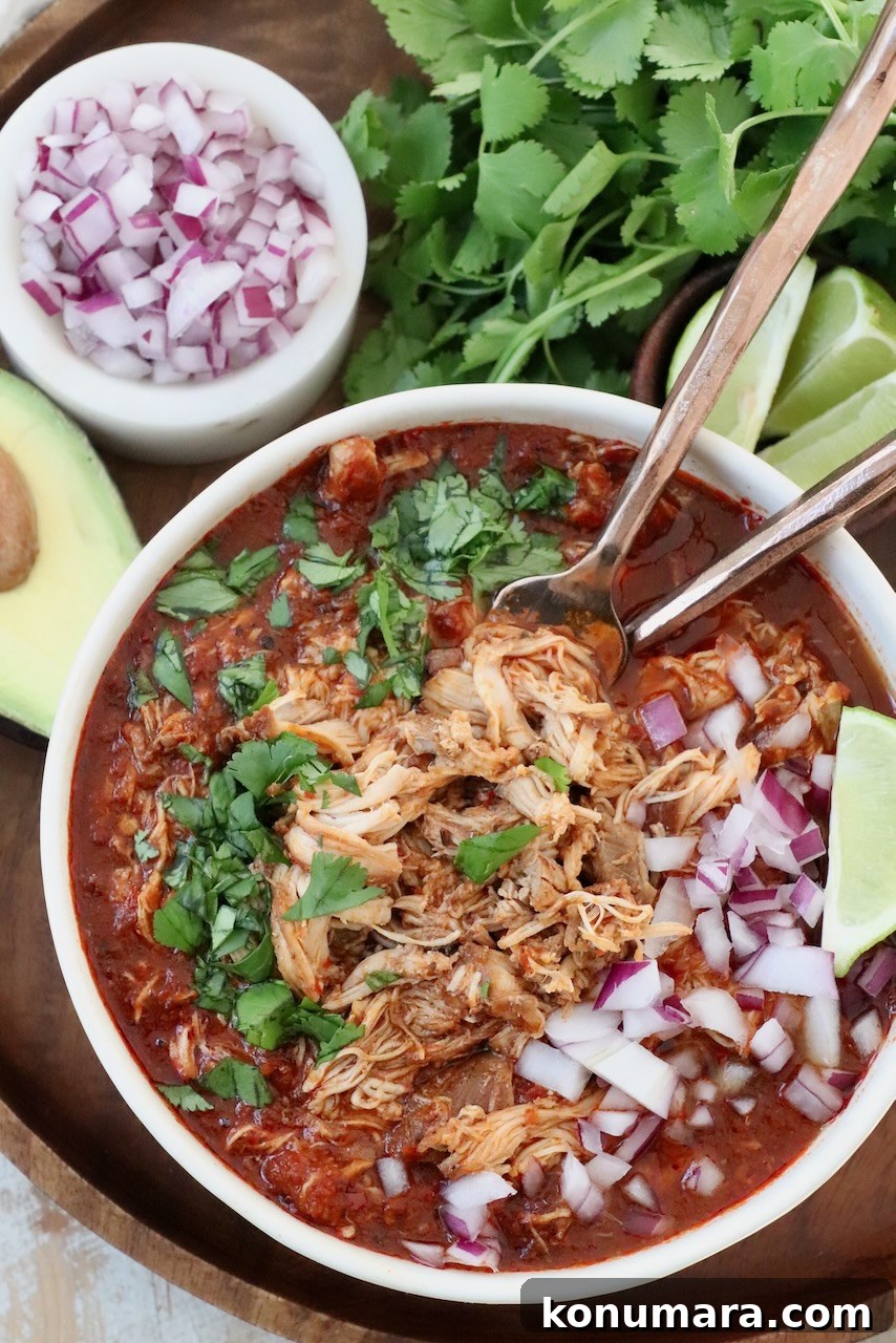 Chicken Birria Tacos with Savory Broth 10 shredded chicken in birria broth in bowl with forks