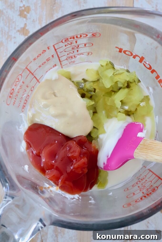 Classic Burger Sauce Recipe for Juicy Homemade Burgers 4 ketchup, dijon mustard, mayonnaise and finely diced pickles in a glass jar