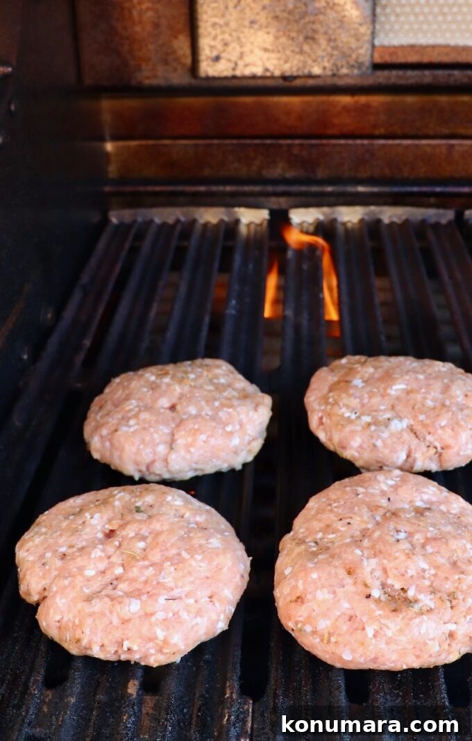 Juicy Turkey Burger Recipe with Savory Seasoning 6 uncooked turkey burger patties on grill