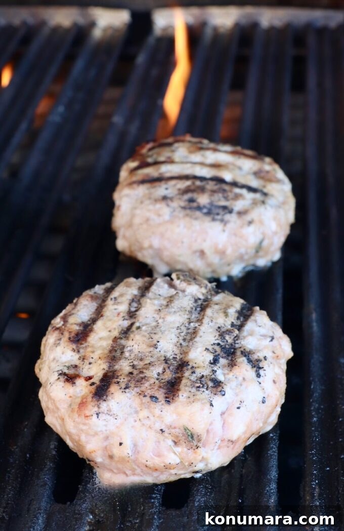 Juicy Turkey Burger Recipe with Savory Seasoning 7 grilled turkey burger patties on grill