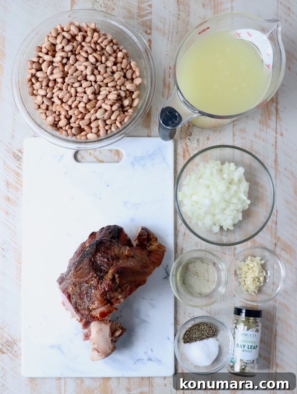 ingredients for pinto beans on white wood board