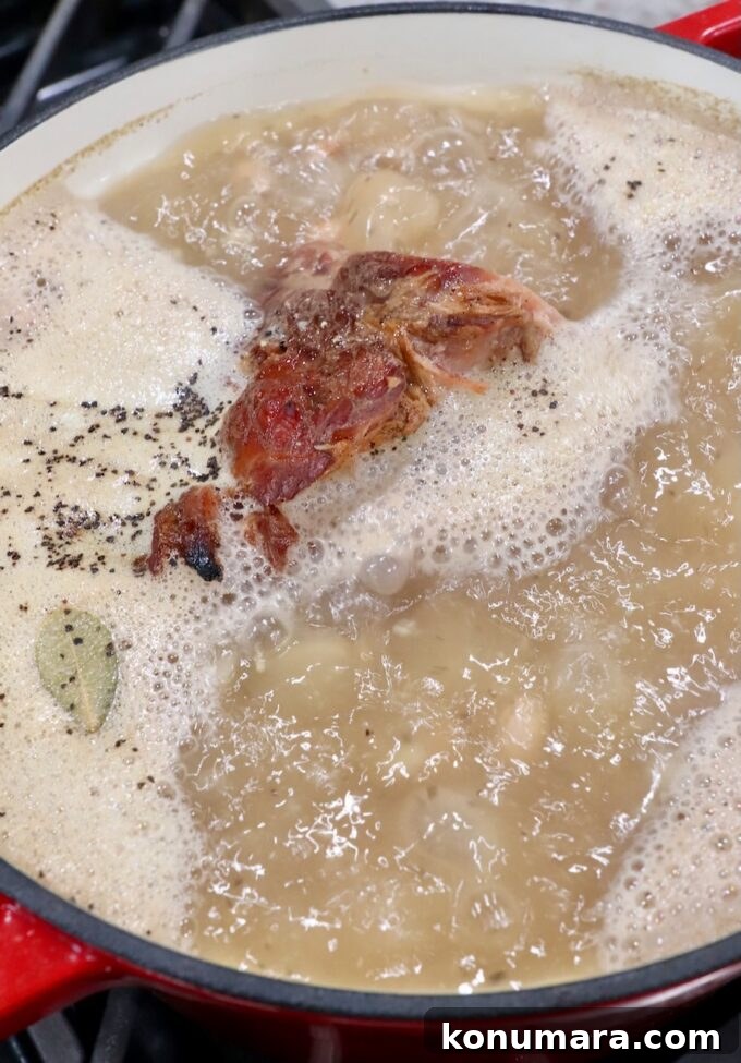 ham bone simmering in liquid in pot