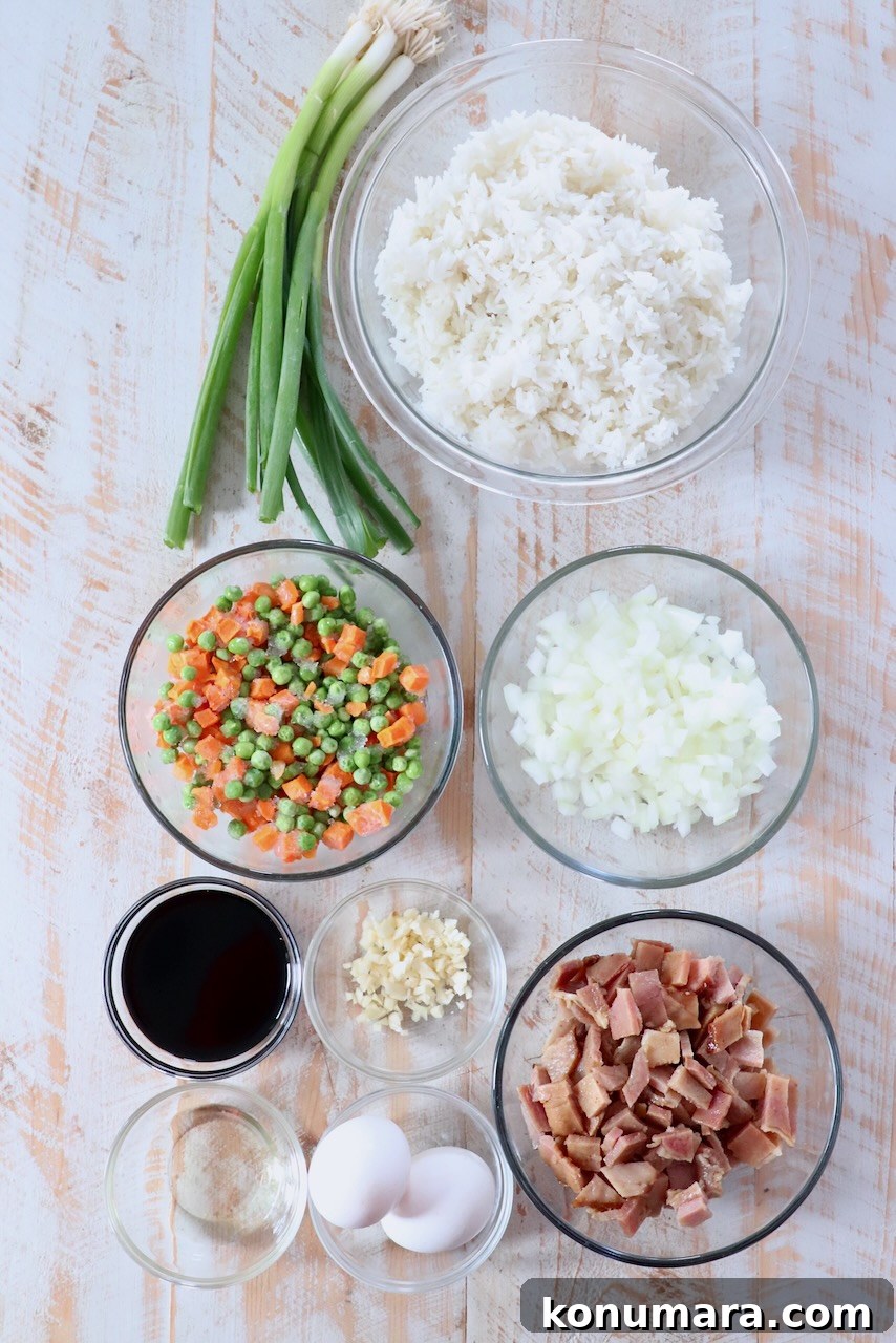 Classic Ham Fried Rice Recipe with Eggs and Peas 3 ingredients for ham fried rice on white wood board