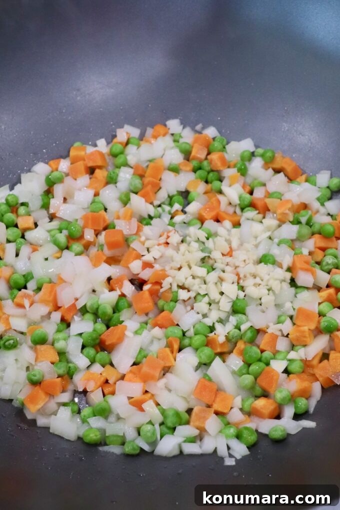 Classic Ham Fried Rice Recipe with Eggs and Peas 4 diced onions, carrots, peas and garlic in large skillet