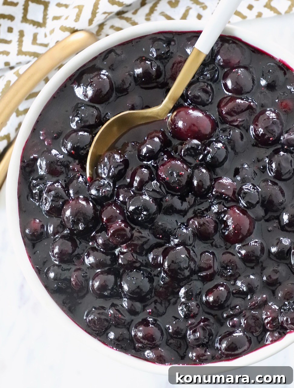 How to Make Homemade Blueberry Pie Filling 2 blueberry pie filling in bowl with spoon