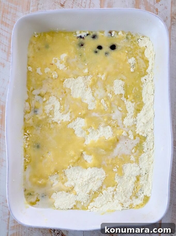 Blueberry Dump Cake Recipe: Irresistible Summer Dessert 5 cake mix covered in melted butter in baking dish