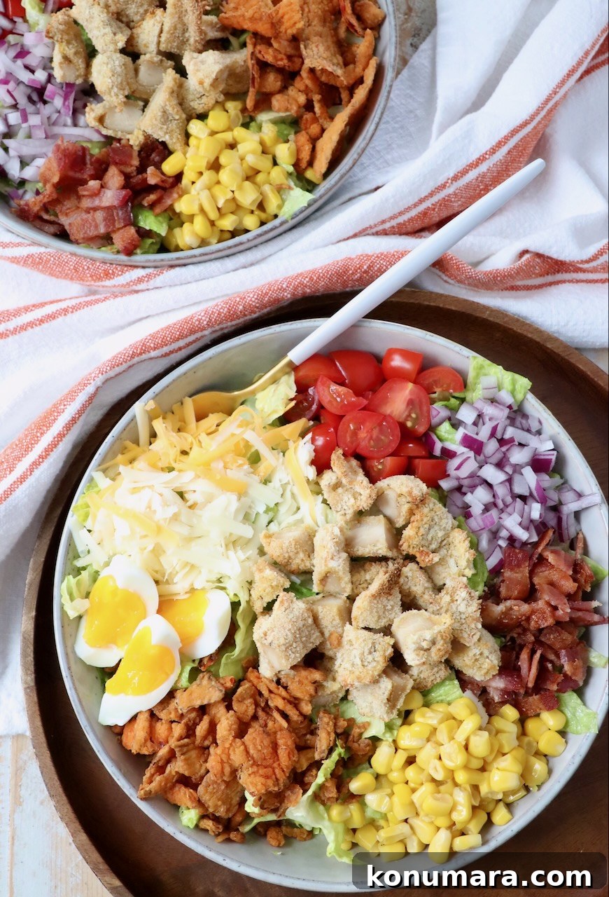 crispy chicken salad in two bowls with fork