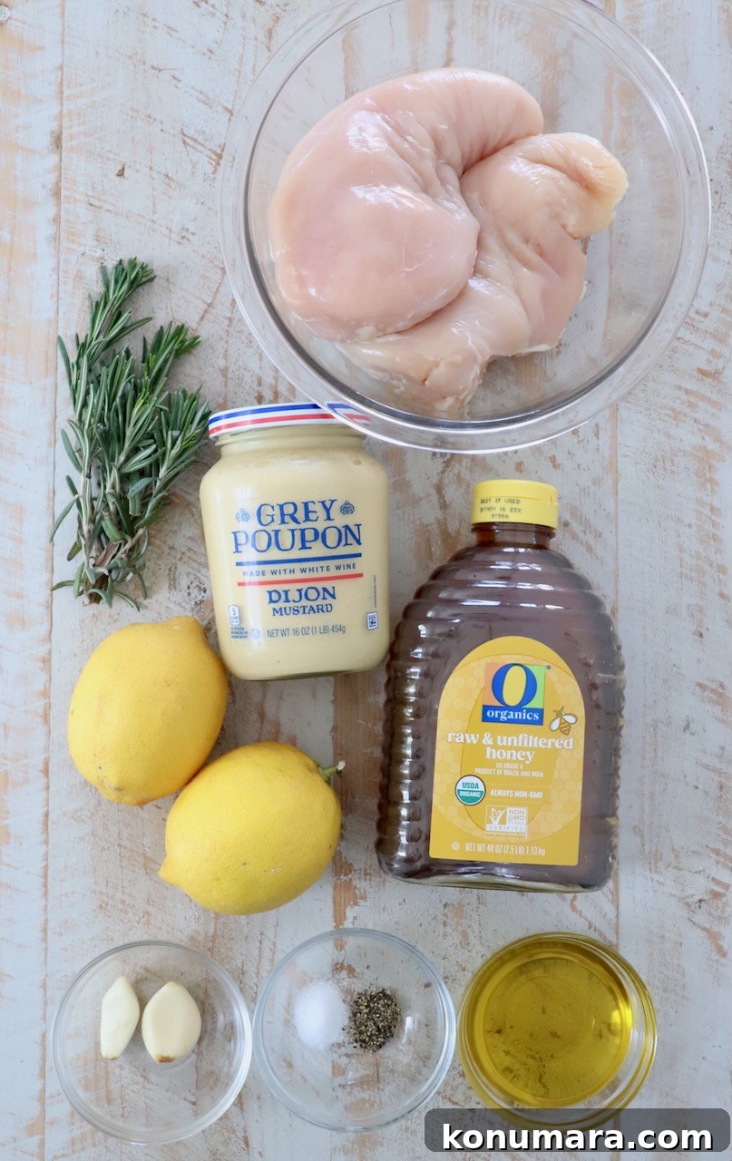 ingredients for honey mustard chicken on white wood board