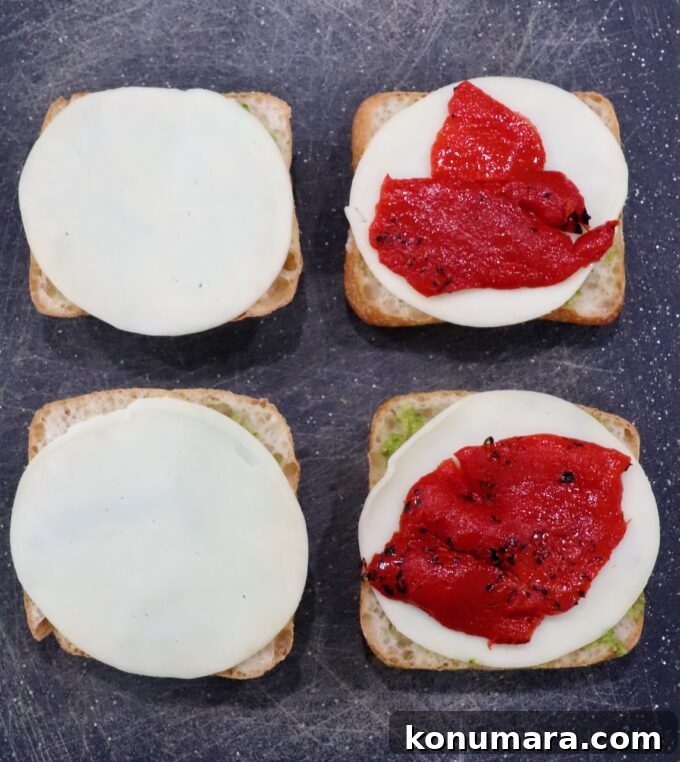Grilled Turkey Pesto Sandwich with Melted Mozzarella 5 roasted red peppers on top of sliced provolone cheese on rolls